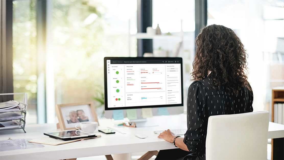 Person sitting at desktop, looking at screen with Cisco dashboard displayed.